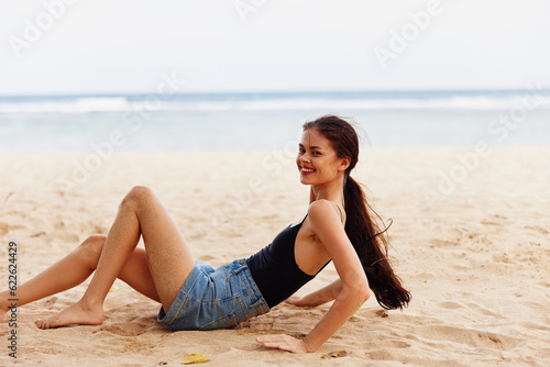 beach woman freedom nature sand sea carefree sitting smile travel vacation