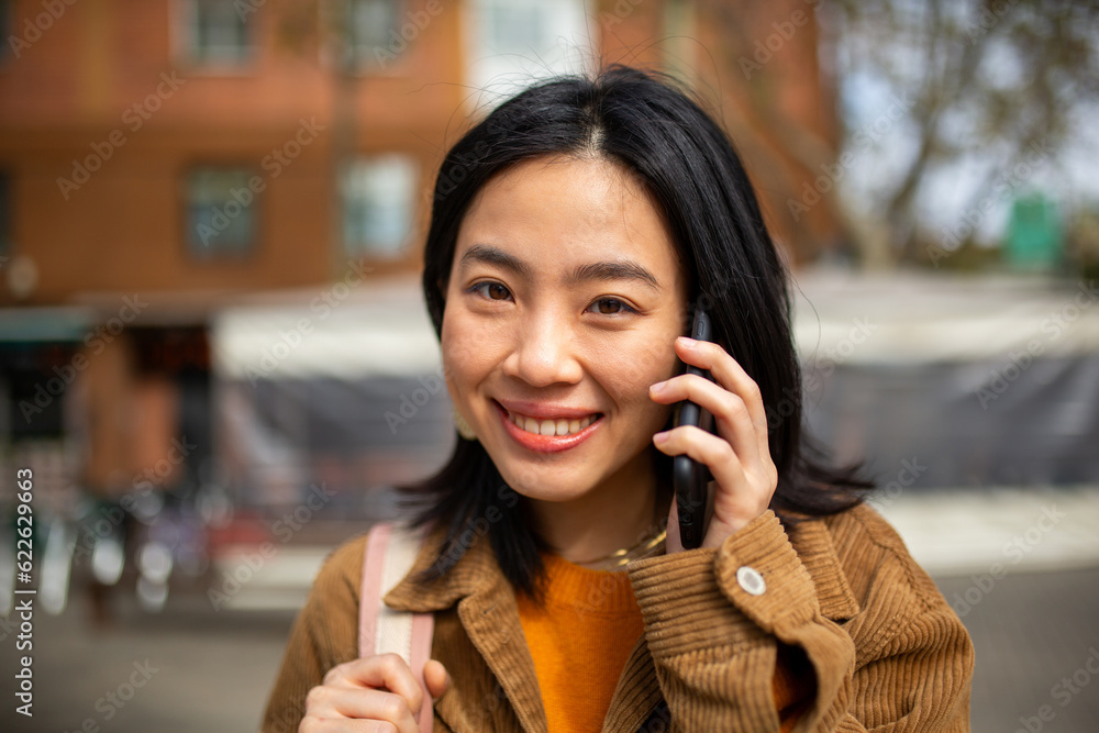 young asian woman talking with cellphone young asian woman talking with cellphone