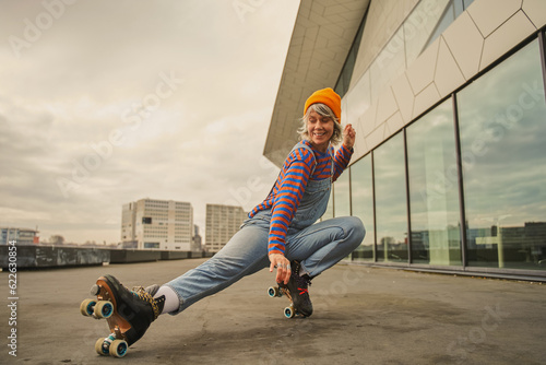 Gorgeous stylish hipster woman roller skating outdoors photo