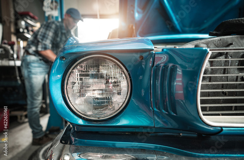 Quadro su tela Classic Cars Restoration Worker Next to His Restored Vehicle