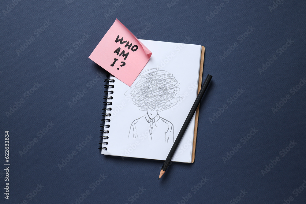 Notepad with pencil drawing and pink note with text on dark blue ...