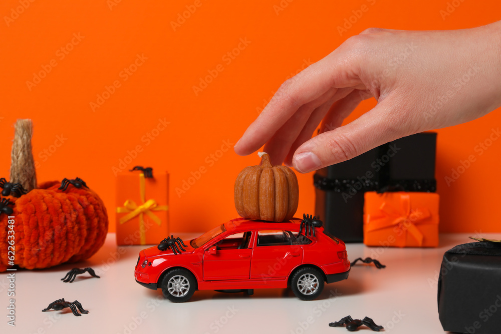 Toy car with gift, pumpkin and knitted black spiders Toy car with gift, pumpkin and knitted black spiders