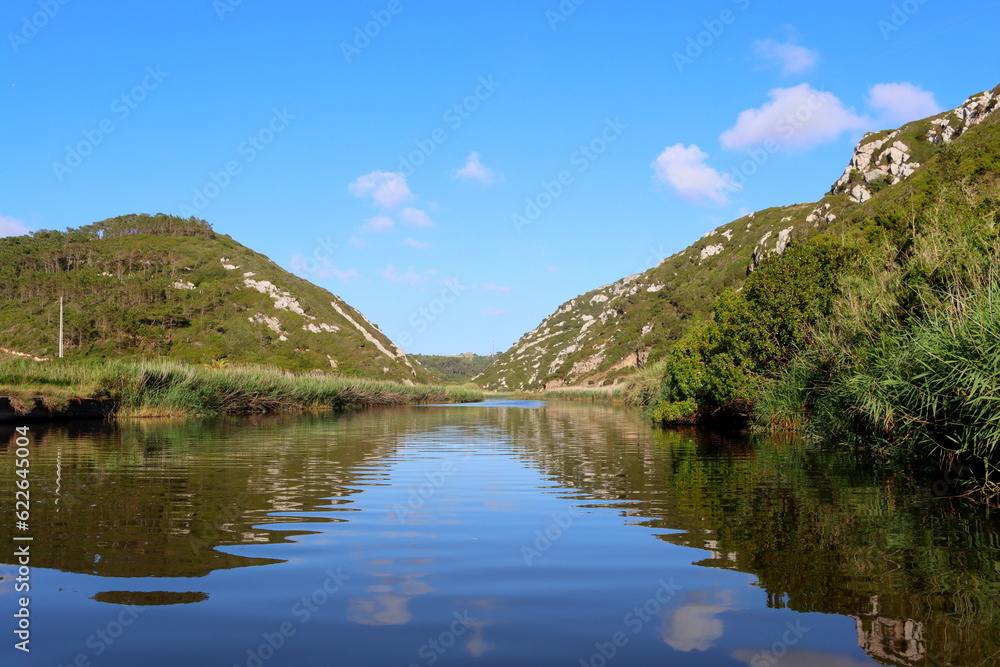 Beautiful summer  Landscape with river, blue sky and white clouds reflected in water. Nature of Portugal.