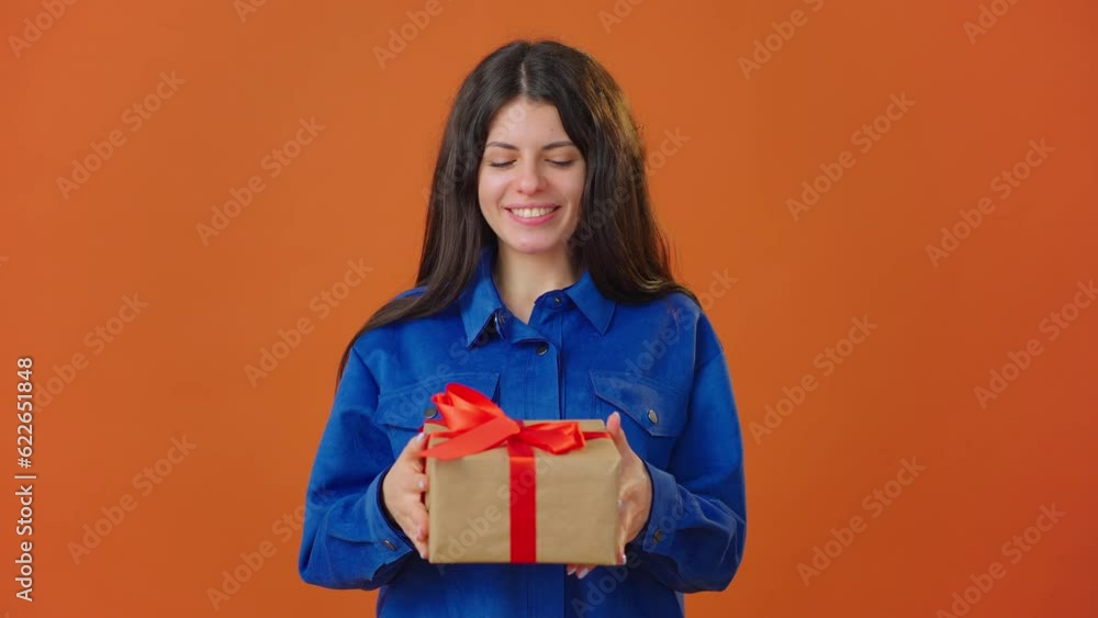 Attractive young woman draws attention and gives gift Attractive young woman draws attention and gives gift