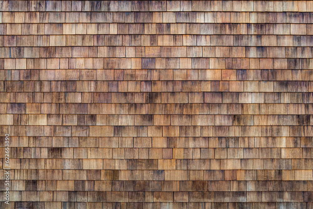 Wood Shake Wall. Wood shake. Grunge cedar tile panel on the exterior wall. Grunge cedar tile panel on the exterior wall. House wall covered with small wooden tiles as a background Wood Shake Wall. Wood shake. Grunge cedar tile panel on the exterior wall. Grunge cedar tile panel on the exterior wall. House wall covered with small wooden tiles as a background