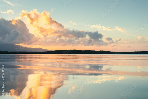 Seven seas beach with calm water reflecting the sky during the golden hour with clouds from fajardo, puerto rico.