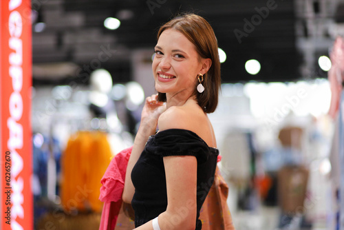 beautiful woman in a clothing store. Young woman shopping for clothes
