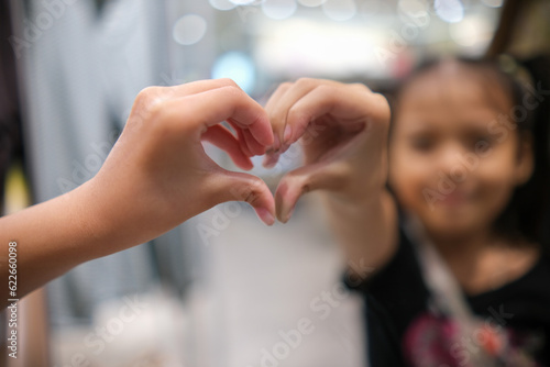 Kid make Hand in heart