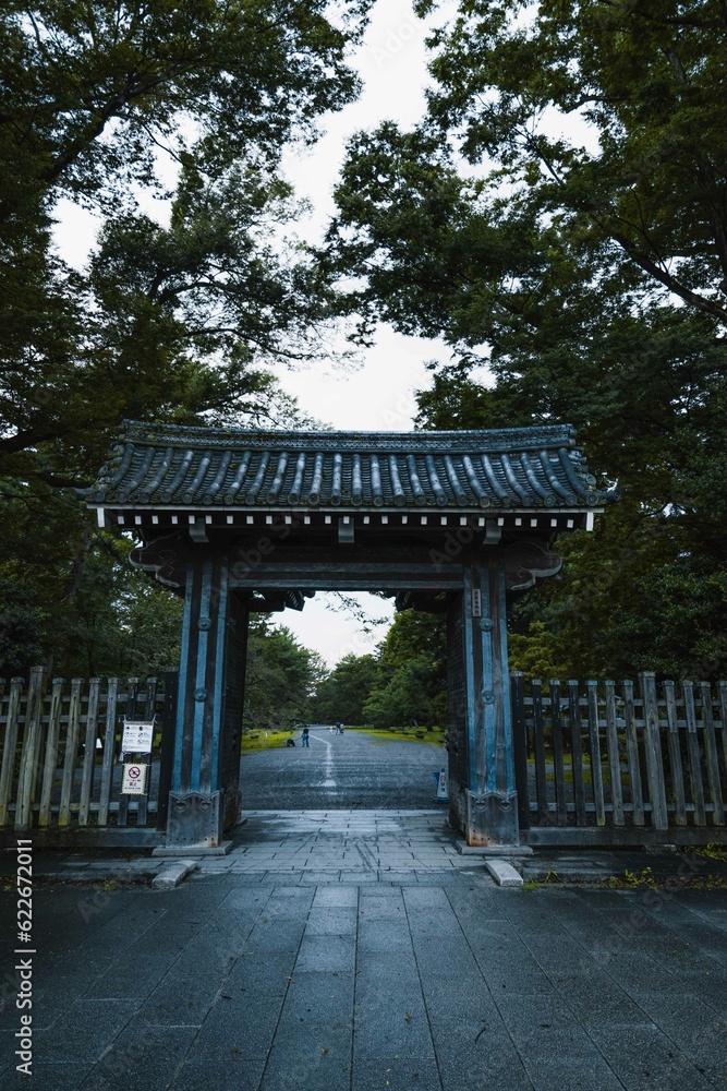 Entrance of a Japanese park with traditional Japanese gate. Japan in summer. Kyoto park Entrance of a Japanese park with traditional Japanese gate. Japan in summer. Kyoto park
