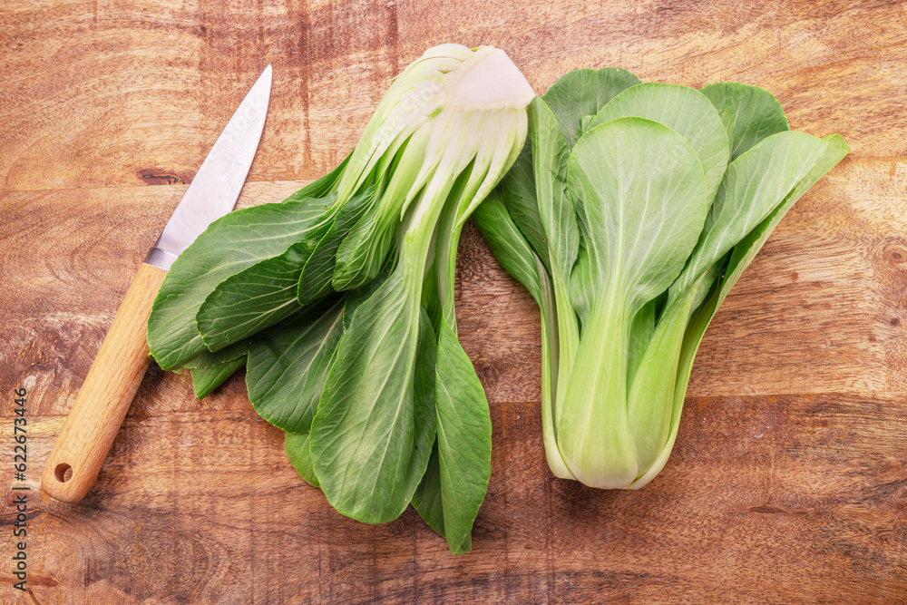 Bok choy or chinese cabbage on wooden background. View above. Bok choy or chinese cabbage on wooden background. View above.