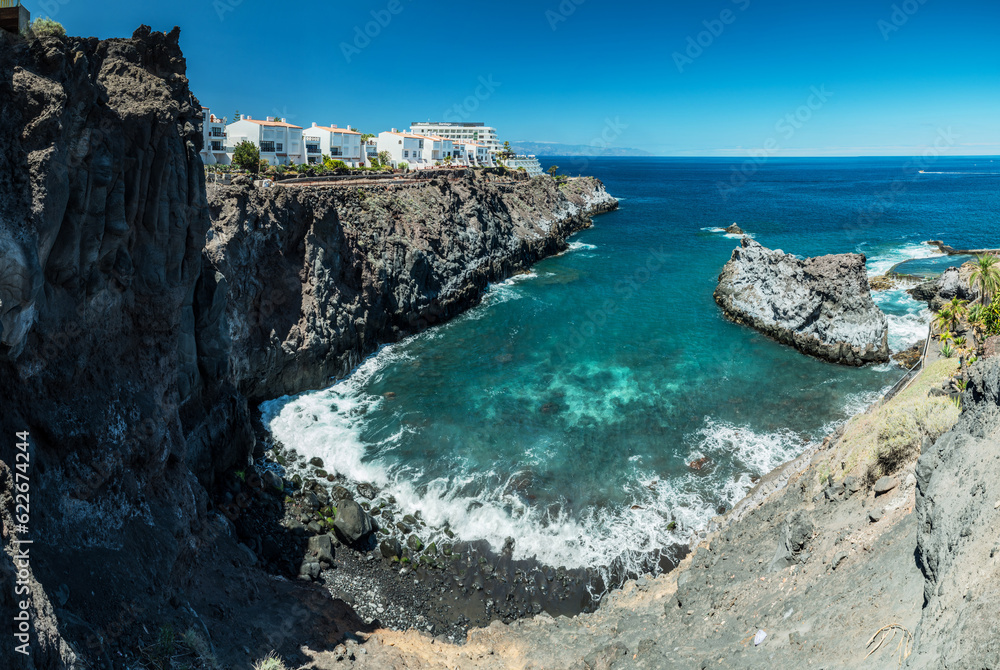 Jagged and dotted rocky coastline with amazing azur water  of Tenerife Island.