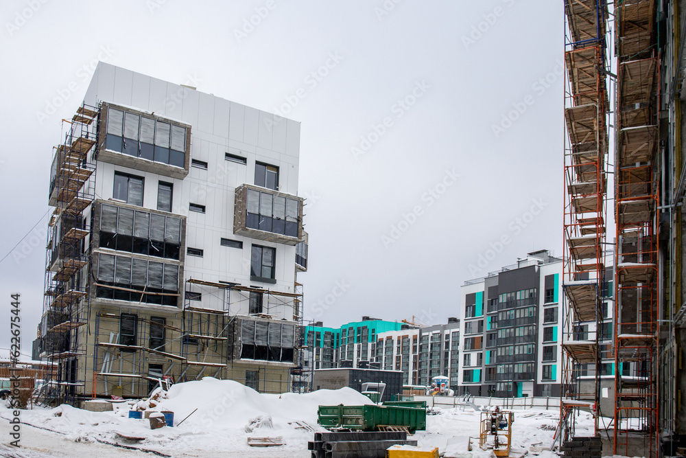 beautiful photo of the construction site of apartment buildings in a residential complex. architecture of stylish houses and scaffolding on houses under construction