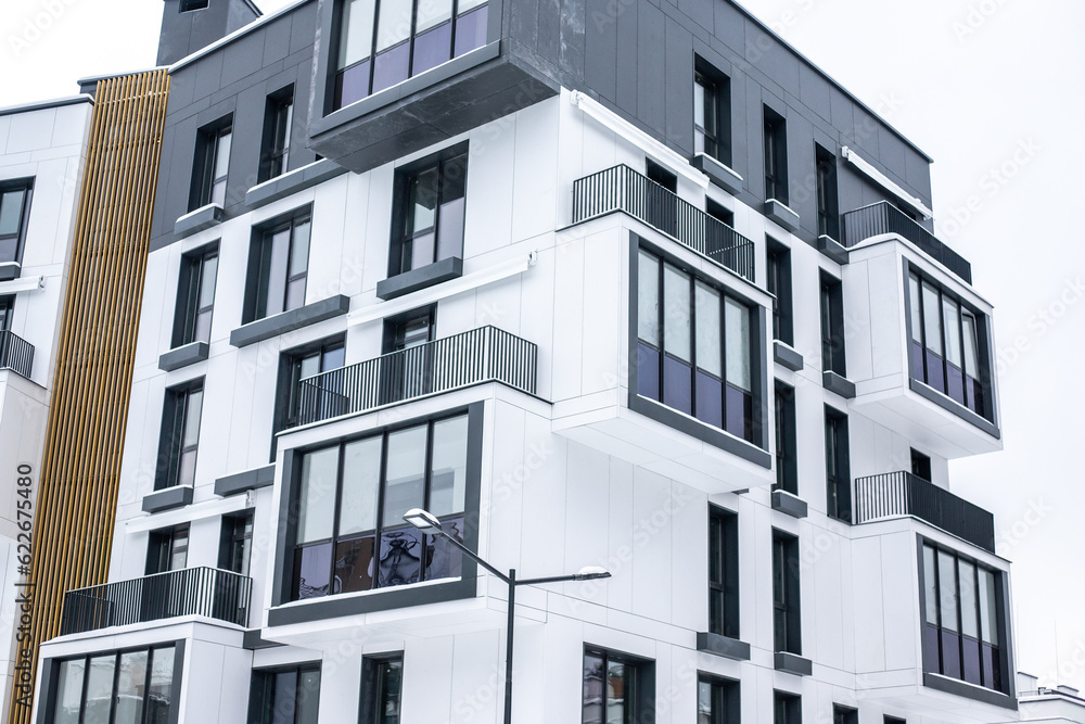 Modern and new apartment building. Multistoried modern, new and stylish living block of flats on a winter snowy day