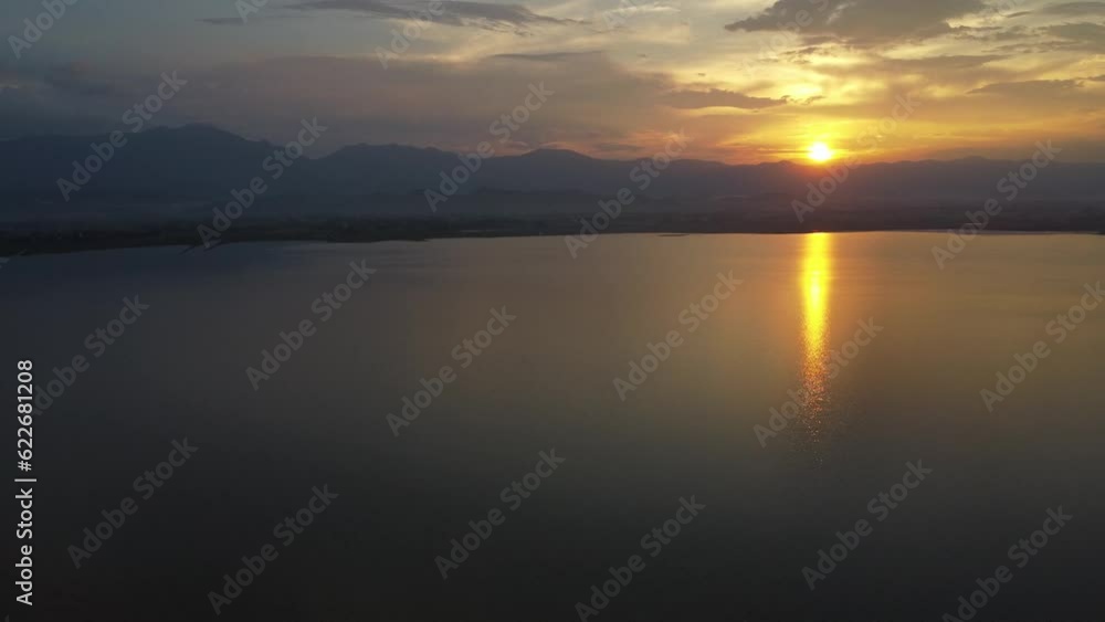 Aerial Drone View of Phayao Lake at Sunset. Majestic Mountain Range and Stunning Water Surface. Aerial Drone View of Phayao Lake at Sunset. Majestic Mountain Range and Stunning Water Surface.
