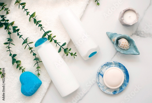 Top view of various cosmetic bottles and containers on white background. Empty plastic container for cosmetics for cream or shampoo. Concept of skin and hair car.