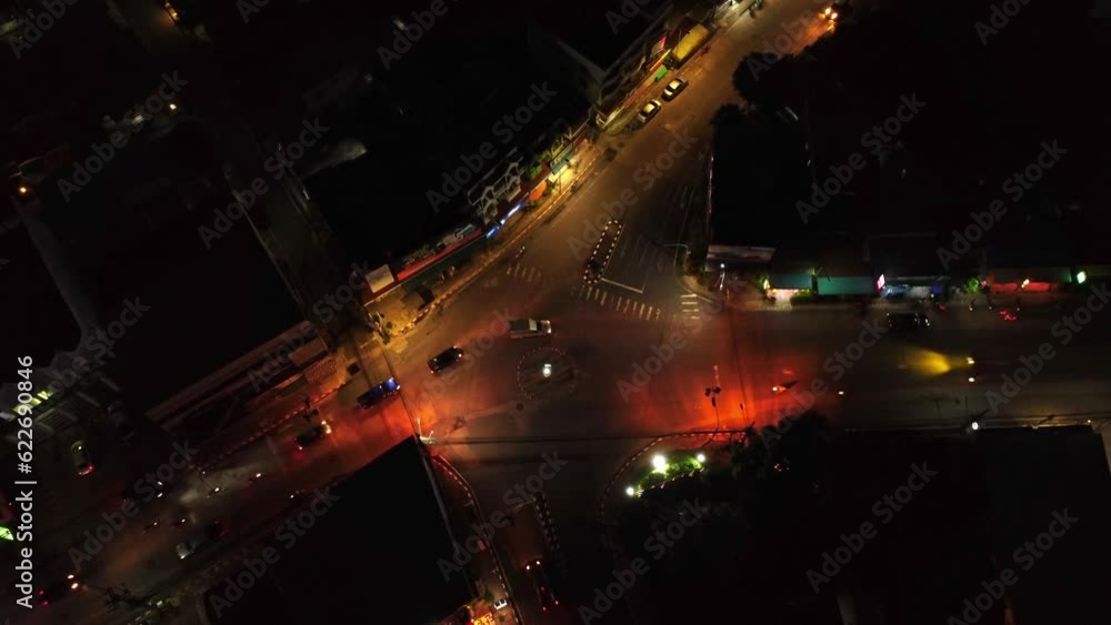 Aerial Drone View of Night Traffic at a Vibrant Neon-Lit Roundabout. Exploring the Dynamic Urban Life. Aerial Drone View of Night Traffic at a Vibrant Neon-Lit Roundabout. Exploring the Dynamic Urban Life.