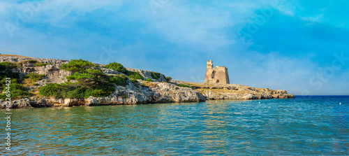 View of an ancient watchtower on a promontory of a beach in the natural park of Gargano, Puglia. Italy