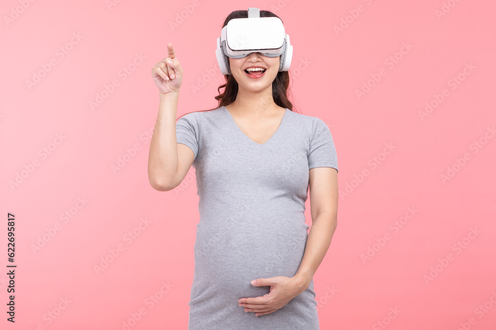 Happy Pregnant Woman using virtual reality glasses standing smile and stroking big belly with love isolated on white background.Pregnancy Metaverse Technology Concept Happy Pregnant Woman using virtual reality glasses standing smile and stroking big belly with love isolated on white background.Pregnancy Metaverse Technology Concept