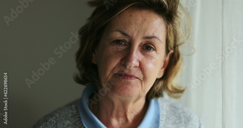 Portrait senior woman face looking at camera with serious expression
