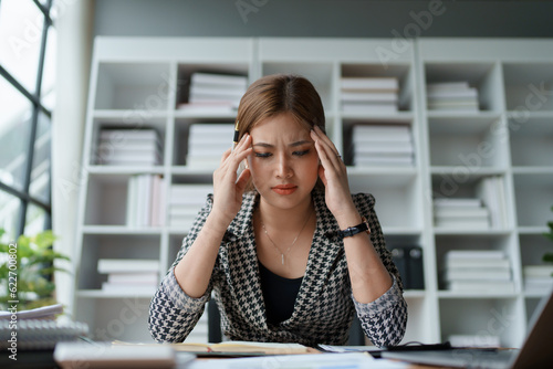 Portrait of business owner, woman using computer and financial statements Anxious expression on expanding the market to increase the ability to invest in business