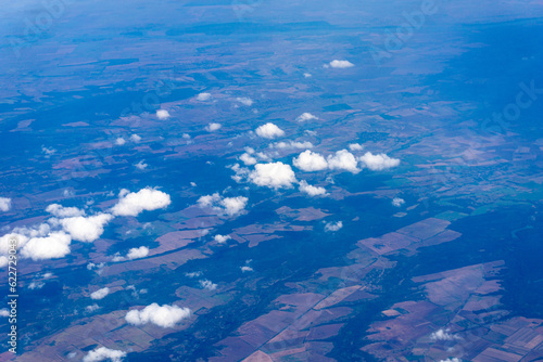 View to a land and clouds from airplane © rninov