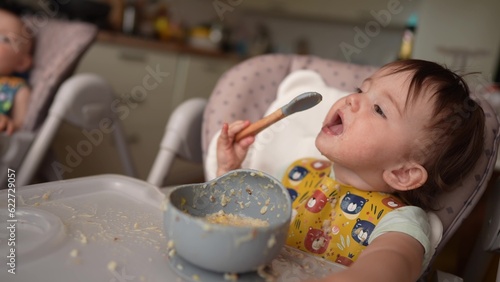 baby dirty eats. happy family toddler concept. baby girl learns to eat with her hands dirty her face dirty funny video dirty. baby on dream the table for feeding eats with her hands from a cup