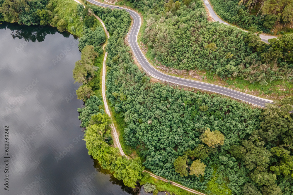 Aerial view of a road driving along the coast of Minho river in Val de Pereira, Ourense, Spain. Aerial view of a road driving along the coast of Minho river in Val de Pereira, Ourense, Spain.