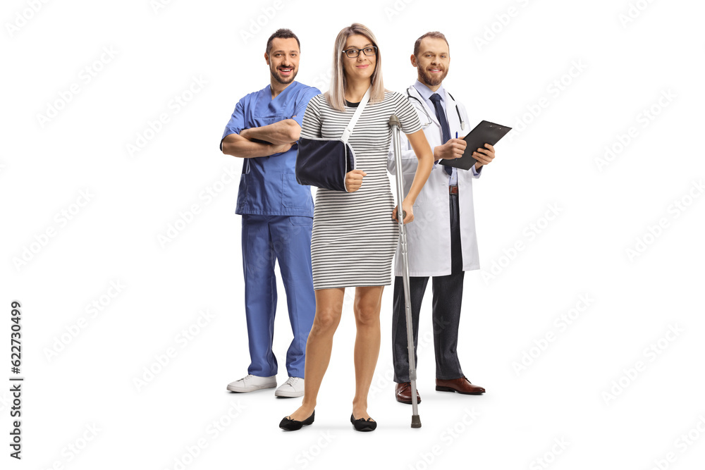 Woman with an injured arm and leg standing with a male doctors