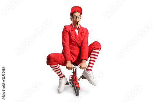 Tableau sur toile Funny entertainer riding a small red bike