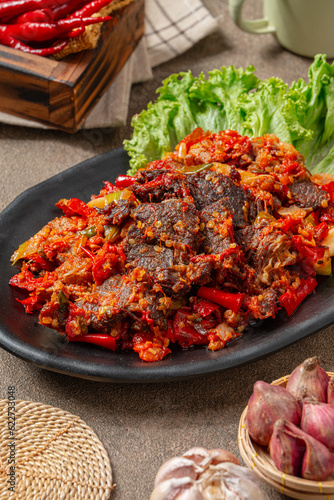 Jerado balado or Dendeng balado is a traditional cuisine from west sumatera, indonesia. it is made from slice of beef with spicy sauce called sambal.