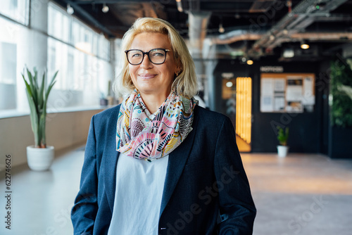 Portrait of smiling 50's stylish, confident mature businesswoman, middle aged company ceo director, experienced senior female professional, business coach team leader in modern office. Female leader photo
