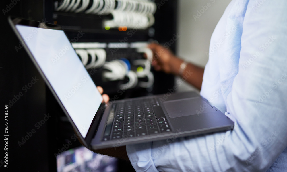 Server room, laptop and IT technician man with internet connection for software programming. Male engineer person with technology for cybersecurity, problem solving or system update in data center Server room, laptop and IT technician man with internet connection for software programming. Male engineer person with technology for cybersecurity, problem solving or system update in data center