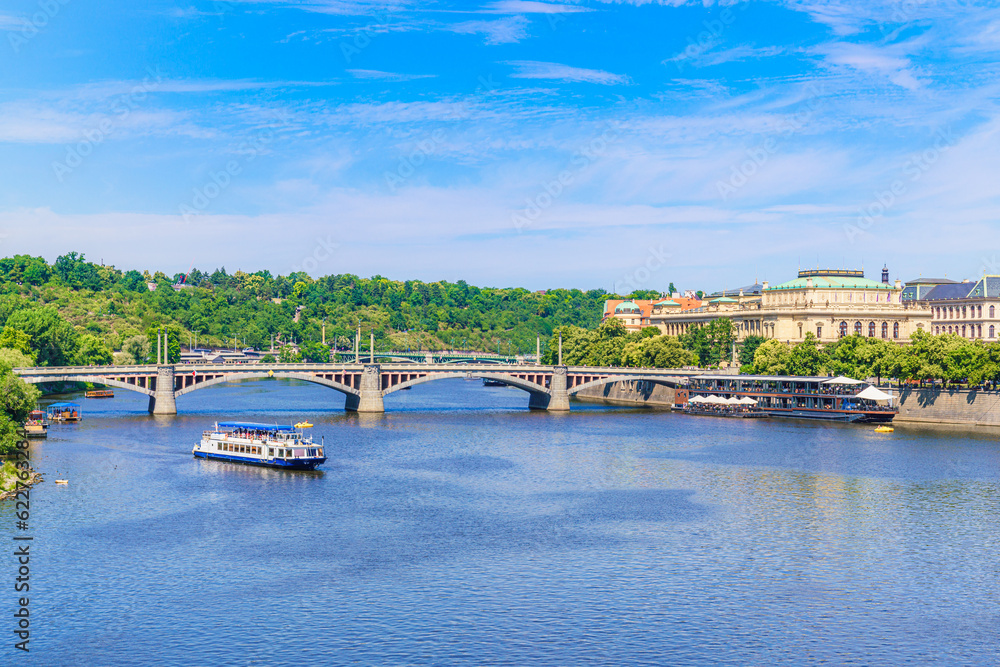 Panoramic view in summertime of River Vltava crossed by Mánes Bridge in Prague