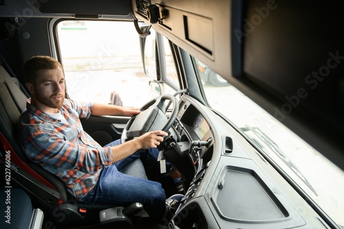 Fotobehang Close up of truck driver behind steering wheel. Copy space.
