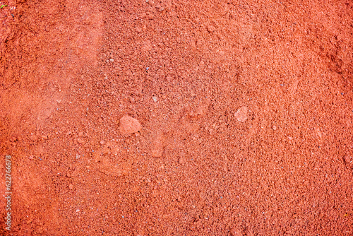 Dry red crushed bricks dust surface. Crushed red brick as a texture background of natural materials