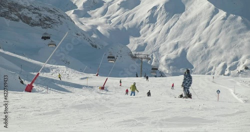 Unrecognizable skiers on ski resort slopes, in Winter. Active, sport, outdoor, mountain.