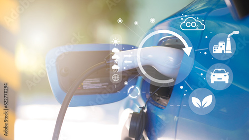 EV charging eco power station for electric car in concept of green energy and eco power produced from sustainable source to supply to charger station in order to reduce CO2 emission .