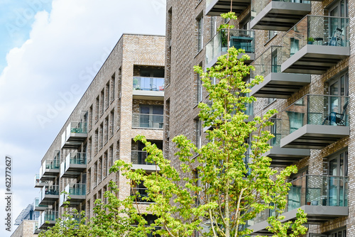 Obraz na płótnie London, UK, 11 July 2023: Modern apartment building with balconies and blue sky