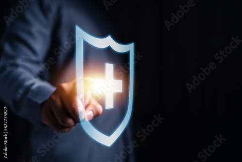 insurance, protection, assurance, family, health, saving, finance, life, shielding, healthcare. businessman's touch on shield hud, symbolizing life insurance for asset and family protection.