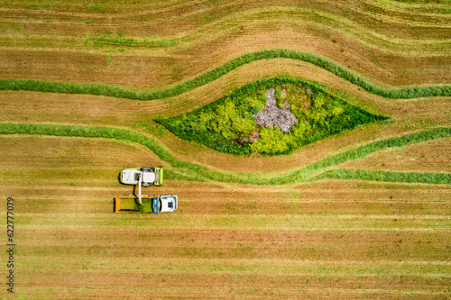 Aerial view of a agricultural machinery at action in a wheat field, kibbutz saar, Israel. photo