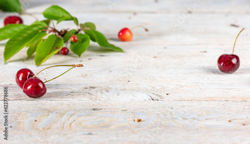 Harmony of Nature: Cherry Harvest on a White Wooden Backdrop