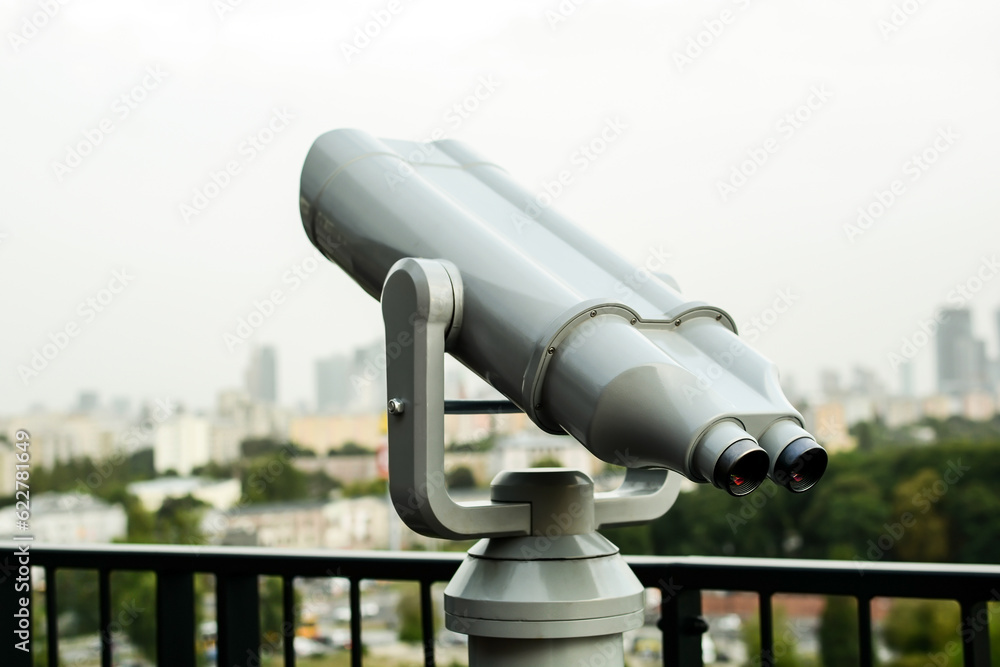 Tourist telescope on the roof overlooking the buildings of the city in Warsaw Tourist telescope on the roof overlooking the buildings of the city in Warsaw