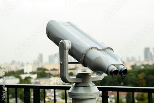 Tourist telescope on the roof overlooking the buildings of the city in Warsaw