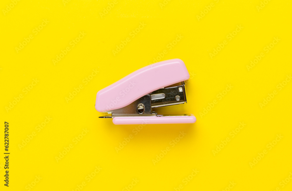 Pink stapler on color backgroung, top view Pink stapler on color backgroung, top view