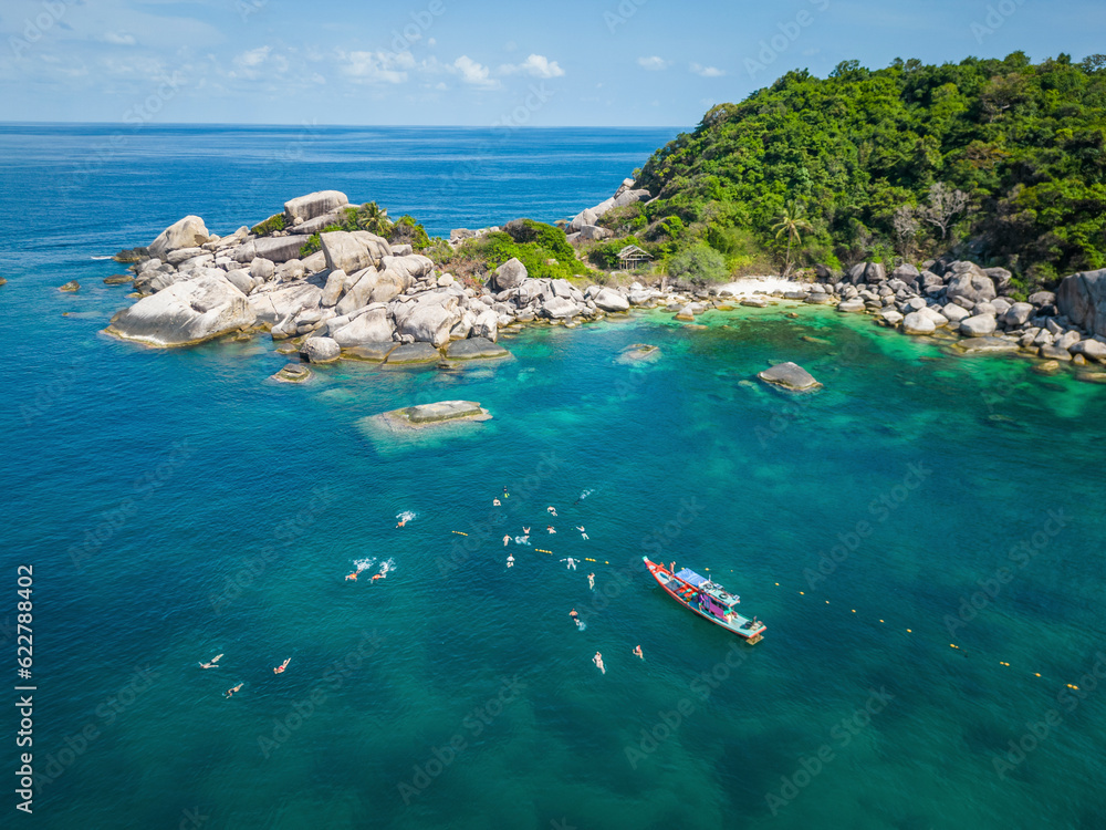 Aerial view of group snorkeling and swimming in transparent sea in shark bay on Ko Tao island, Thailand. Aerial view of group snorkeling and swimming in transparent sea in shark bay on Ko Tao island, Thailand.