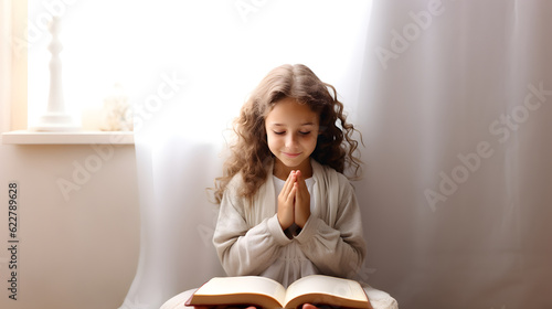 Obraz na plátně Cute child girl reading bible book. Worship at home. AI generated