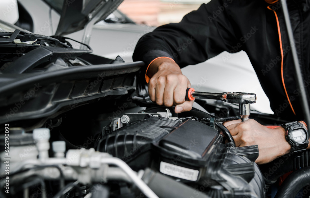 Mechanic fixing a car at home. Repair and service. Mechanic fixing a car at home. Repair and service.
