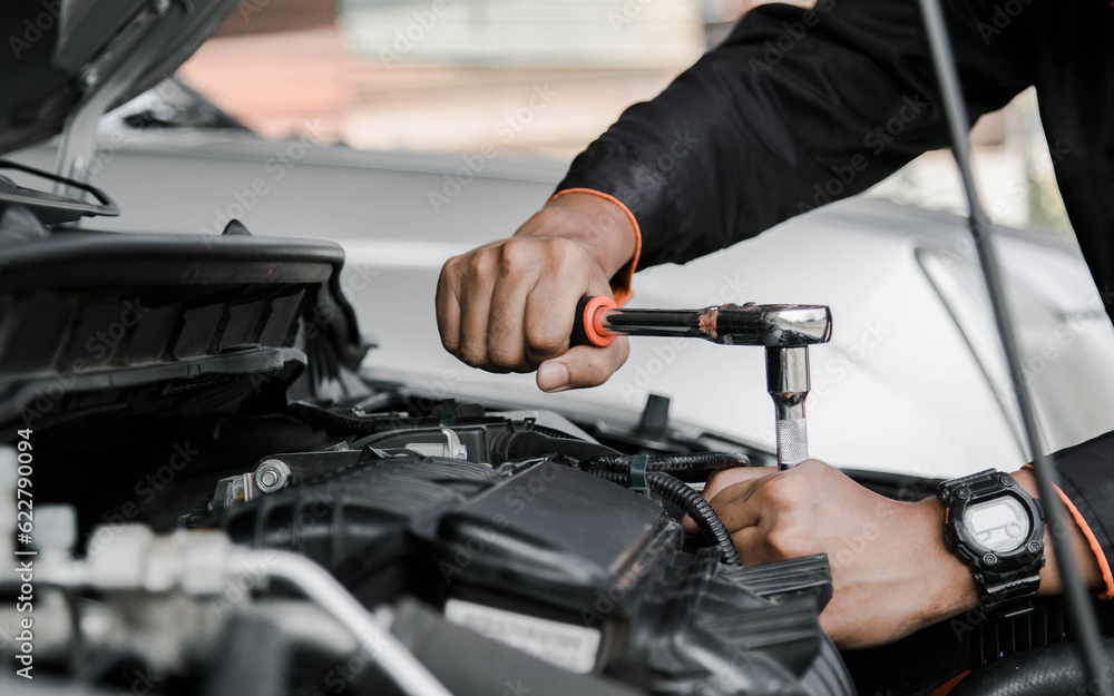 Mechanic fixing a car at home. Repair and service.