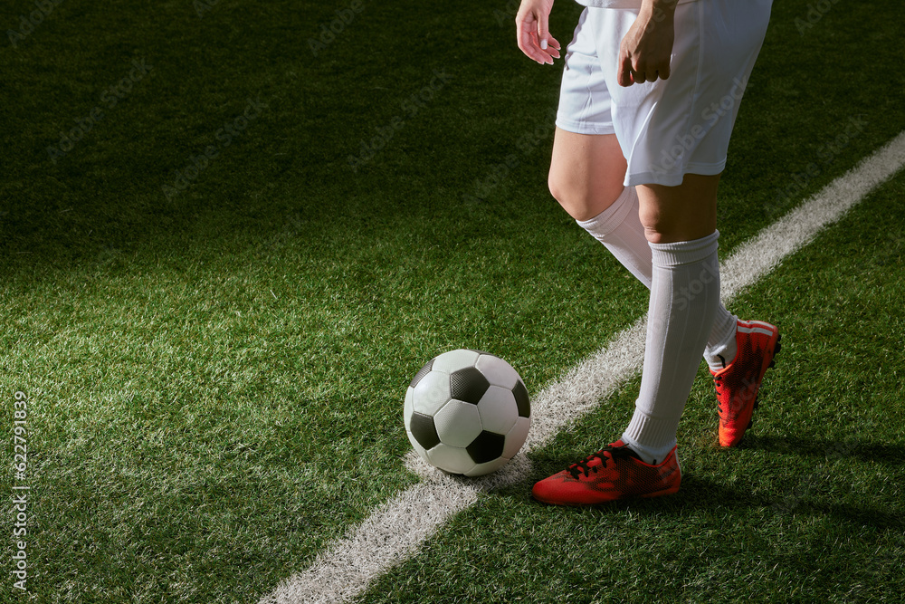 Obraz premium sports girl football player with a soccer ball on the soccer field, the concept of professional women's football