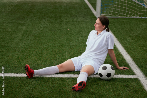 sports girl football player with a soccer ball on the soccer field, the concept of professional women's football